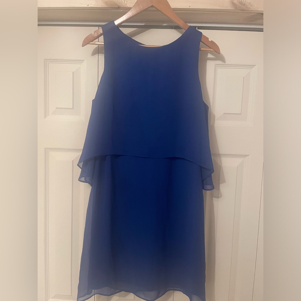 Royal blue knee length dresss. Silk sheen overlay has a tear on side; cocktail